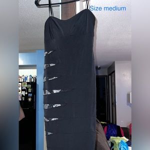 Black dress with metallic beading. Form fitting dress.